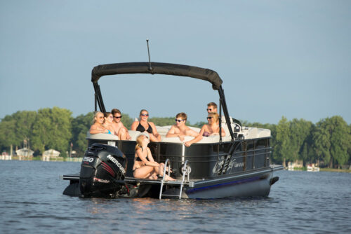 Girl on the deck of a triple pontoon boat with Bridge Marina in Highlands
