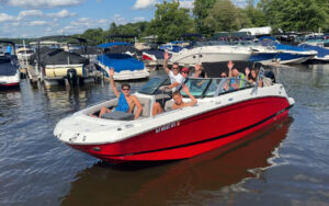 Happy boat club members leaving Bridge Marina on a premium boat at Lake Hopatcong, ready for a carefree day on the water.
