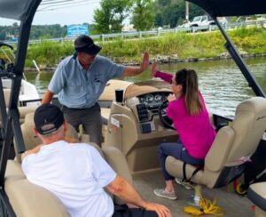 Boating lesson participants learn to boat with hands-on experience aboard a Bridge Marina fleet boat.