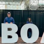 Smiling Bridge Marina team members at the New York Boat Show holding an ‘I heart Boats’ display at the Javits Center in New York City