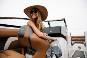 Smiling woman on a Four Winns boat with Bridge Marina