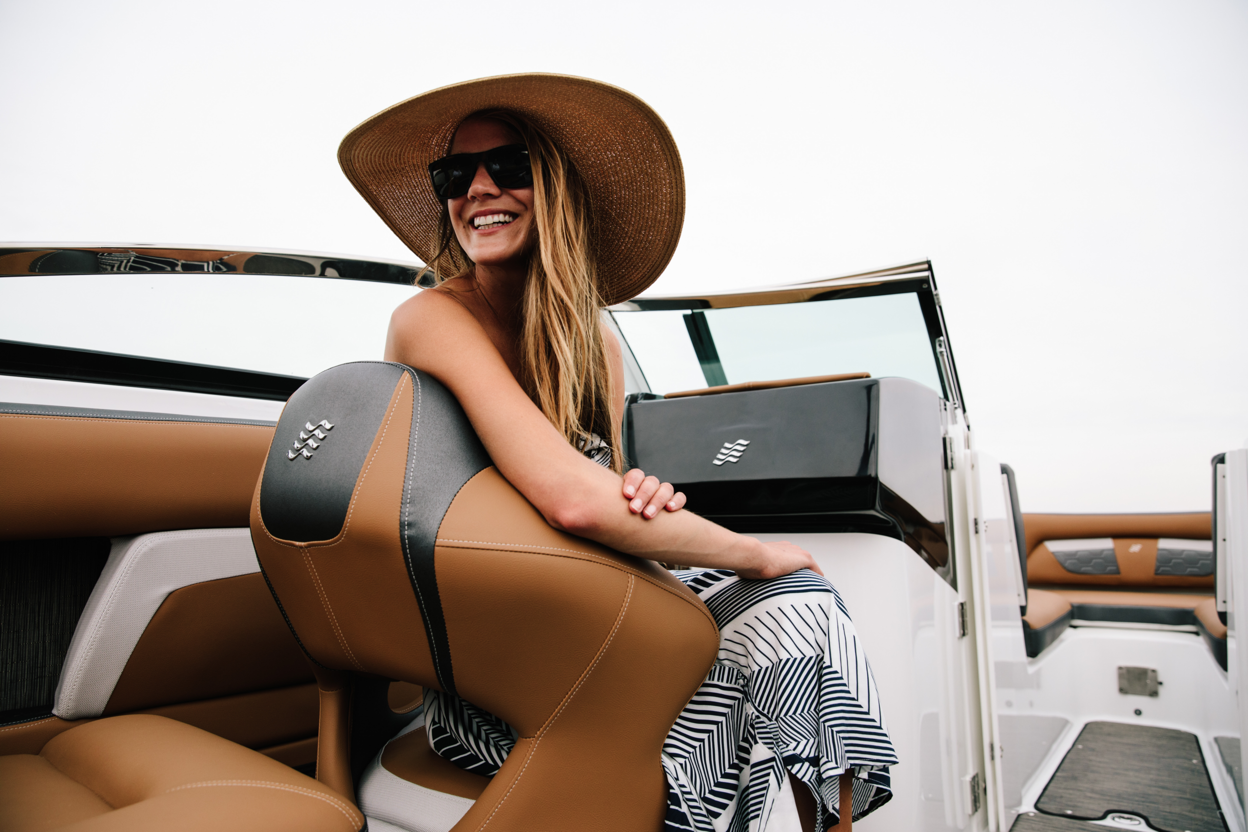 Smiling woman on a Four Winns boat with Bridge Marina