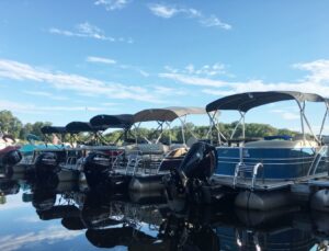 A row of rental pontoon boats docked at Bridge Marina on Lake Hopatcong, NJ.