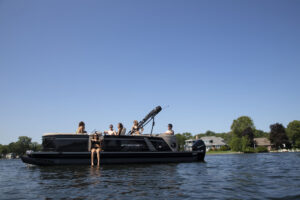 A smiling group aboard a pontoon boat rental on Lake Hopatcong. 