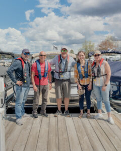 A group of Bridge Marina boating lesson students smile on the docks on Lake Hopatcong.