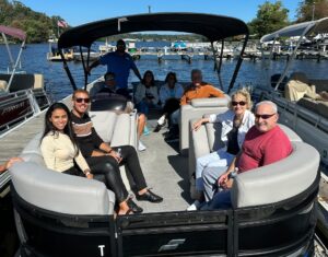 Smiling passengers aboard a Bridge Marina Boat Rental on Lake Hopatcong.