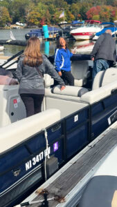 Comparing boats for sale aboard a pontoon boat on Lake Hopatcong
